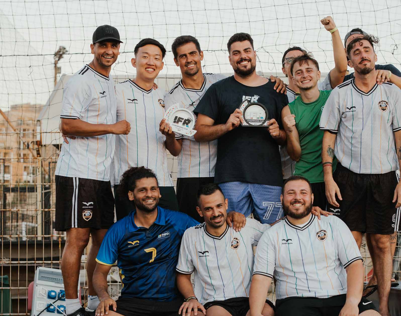 NEO Group football team celebrating at the IFR Champions Cup